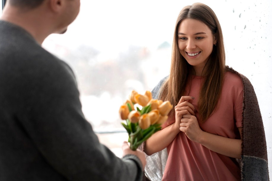 Woman smiles when given flowers, capturing the joy of thoughtful compliments.