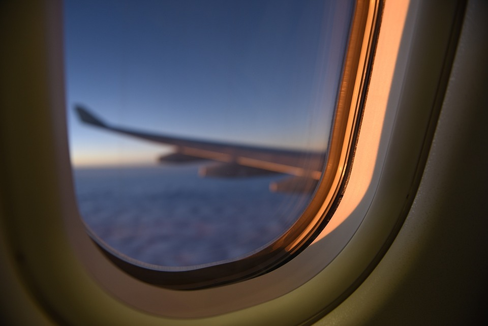 Close-up of airplane window, showing the layered panes that balance pressure.