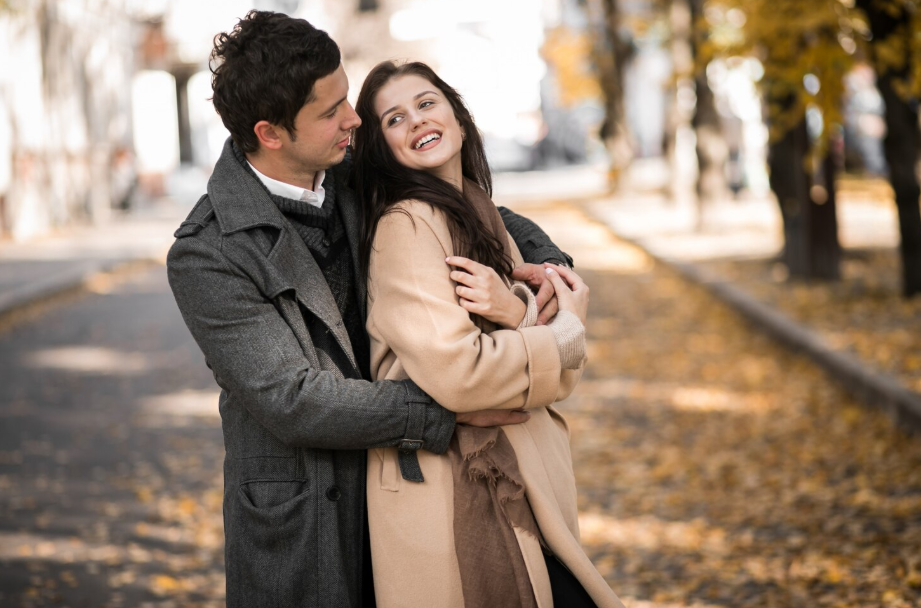 Couple hugging on an autumn street, illustrating the neuroscience of falling in love through touch.