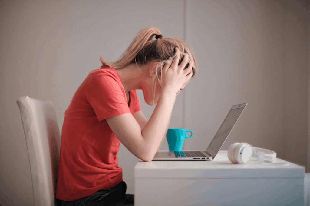Stressed woman holding her head, illustrating why stress disrupts focus