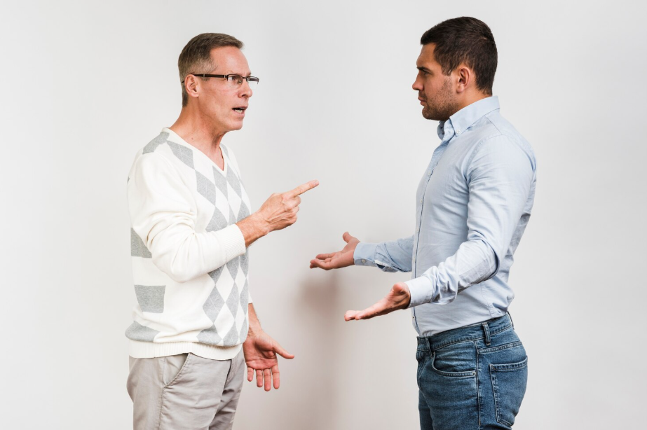 Two men arguing face-to-face, one pointing. illustrates confirmation bias